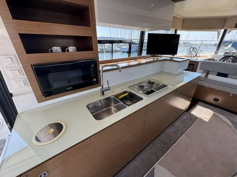Slide: The Image of The galley of a 2016 Fountaine Pajot Motor Yacht 37 with sink, stove, and microwave. - 8