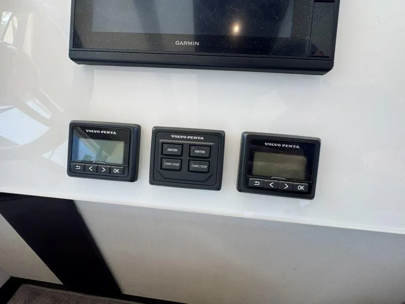 Slide: The Image of Three Volvo Penta control panels and a Garmin screen are mounted on a white wall. - 21