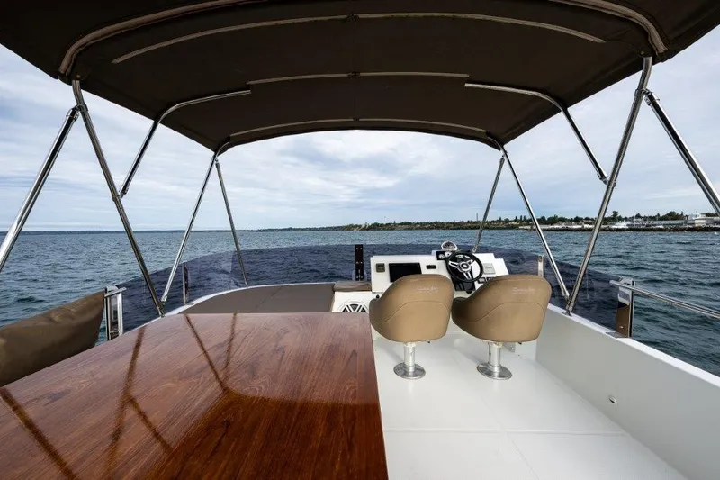 Slide: The Image of The image shows the cockpit of a 2016 Fountaine Pajot Motor Yacht 37 with two seats and a table. - 8