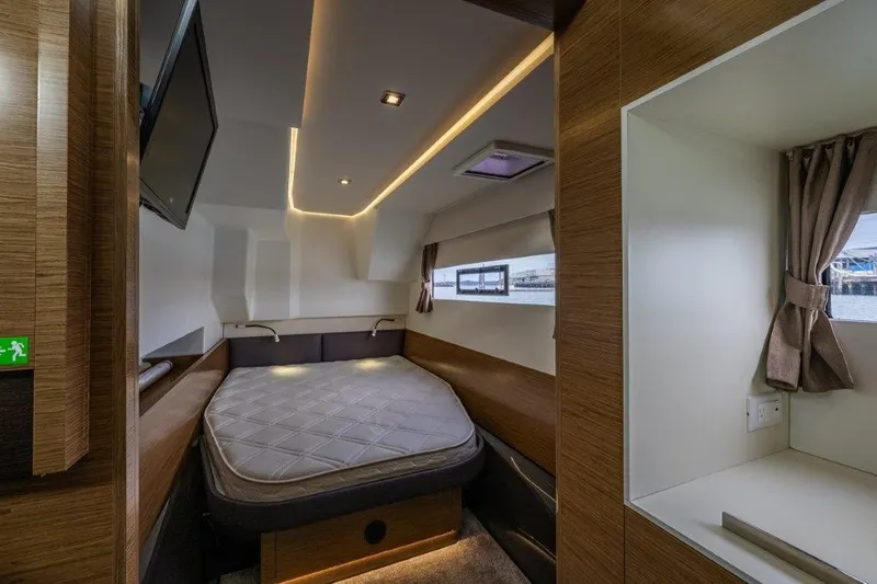 Slide: The Image of The image shows a modern cabin with a double bed, wood paneling, and a window. - 29