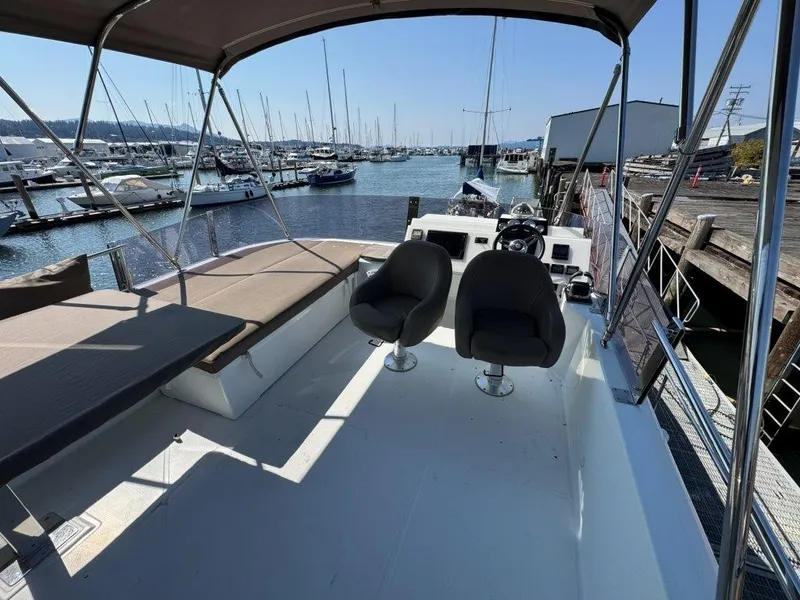 Slide: The Image of The image shows the deck of a 2016 Fountaine Pajot Motor Yacht 37 in a marina. - 43