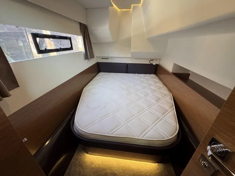 Slide: The Image of The cabin of a 2016 Fountaine Pajot Motor Yacht 37 features a cozy bed with lighting. - 33