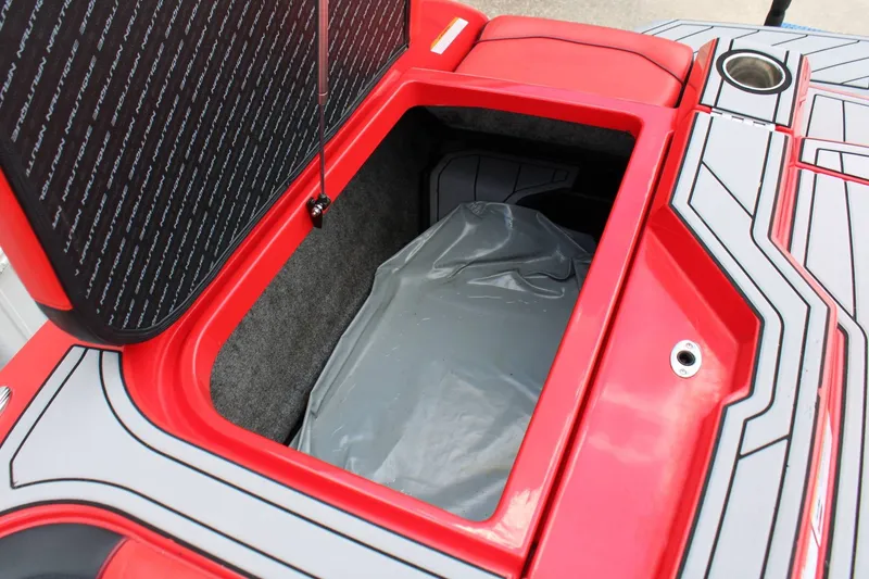 Slide: The Image of A red storage compartment on a boat with a gray interior and a cup holder. - 24