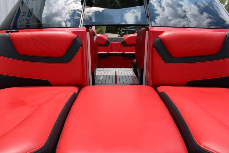 Slide: The Image of The image shows the interior of a 2021 Nautique Super Air Nautique GS22 with red seating. - 6