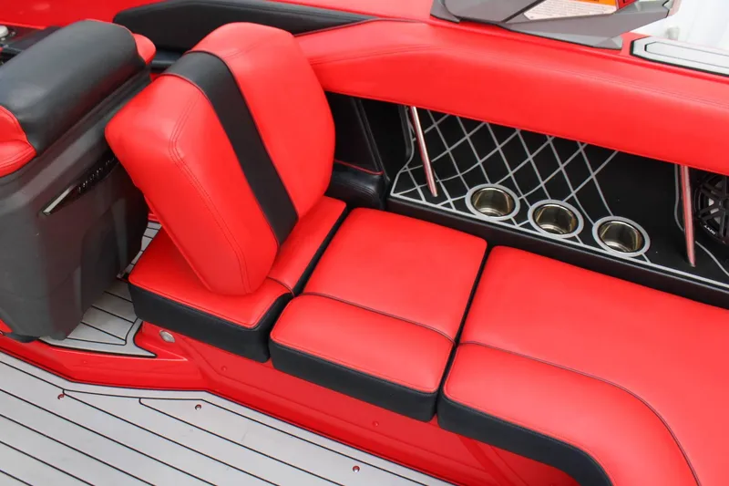 Slide: The Image of Red and black upholstery on a boat seat with cup holders and a modern design. - 16