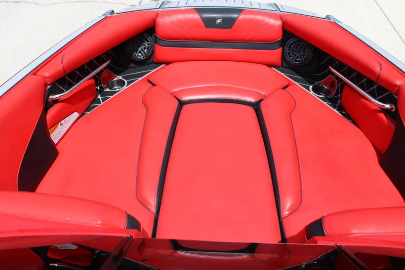 Slide: The Image of The image shows the red interior of a 2021 Nautique Super Air Nautique GS22 boat. - 5