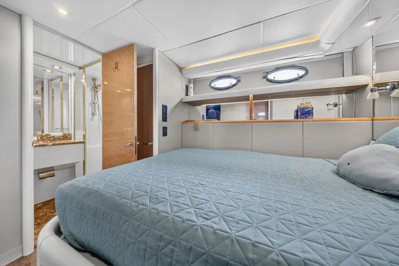 Slide: The Image of Luxurious cabin with a large bed, elegant wood accents, and an adjoining bathroom. - 35