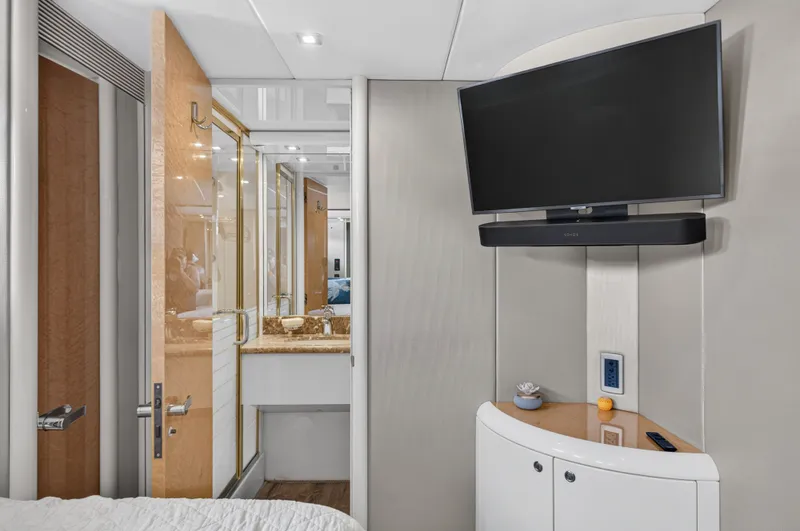 Slide: The Image of Luxurious cabin with flat-screen TV, elegant bathroom, and modern design on a Lazzara 80 SL yacht. - 34