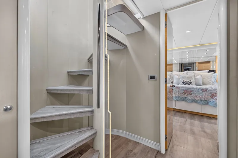 Slide: The Image of A sleek staircase leads to a luxurious bedroom with a large, decorative bed. - 22