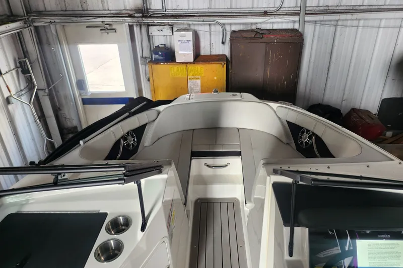 Slide: The Image of 2022 Sea Ray SPX 210 Outboard boat interior in a storage facility. - 10