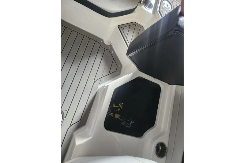 Slide: The Image of 2022 Sea Ray SPX 210 Outboard interior with sleek flooring and storage compartment. - 14