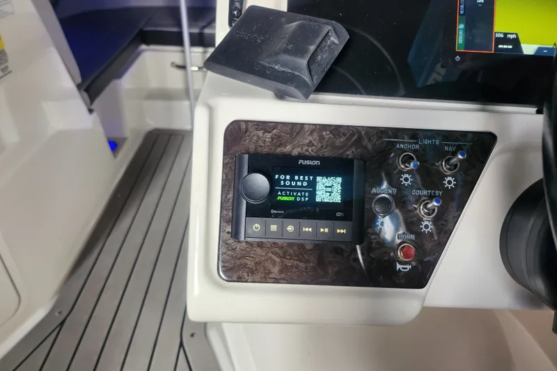 Slide: The Image of 2022 Sea Ray SPX 210 Outboard dashboard with Fusion audio system and control panel. - 3