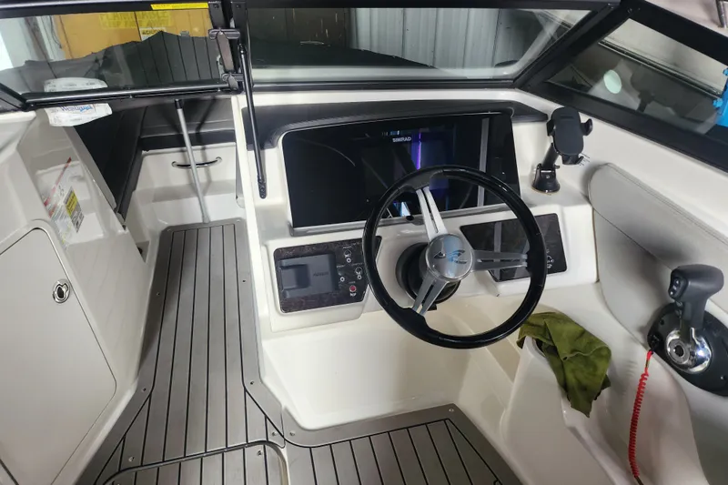 Slide: The Image of 2022 Sea Ray SPX 210 Outboard boat cockpit with steering wheel and control panel. - 2