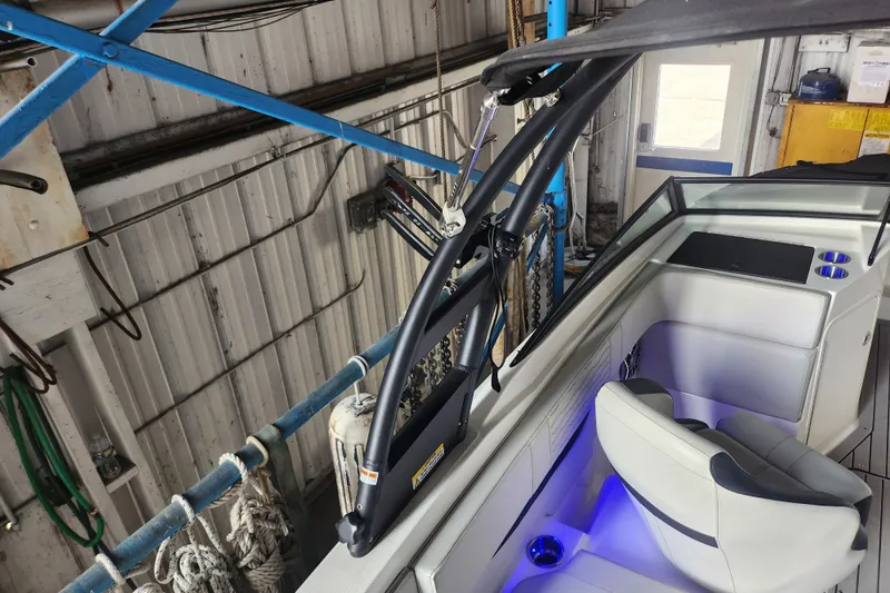 Slide: The Image of 2022 Sea Ray SPX 210 Outboard interior with seating and blue LED lighting. - 8