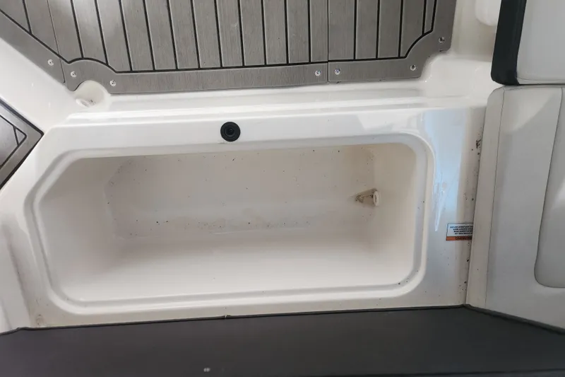 Slide: The Image of 2022 Sea Ray SPX 210 Outboard storage compartment with sleek design and durable materials. - 13