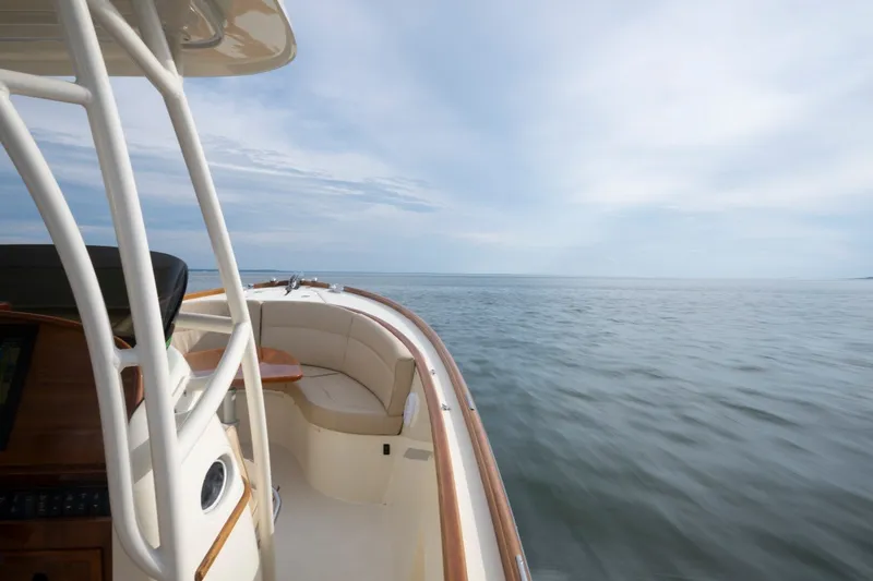 Slide: The Image of 2014 Hinckley Talaria 29C cruising on open water under a clear sky. - 22
