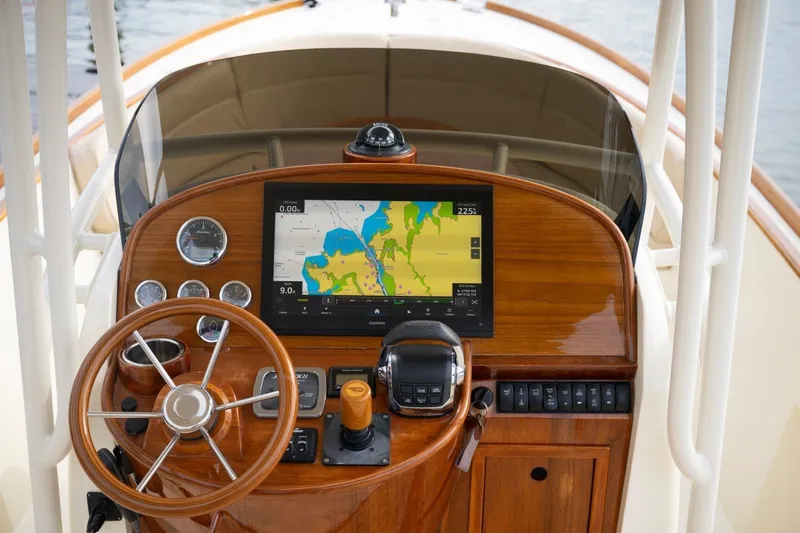 Slide: The Image of Helm of 2014 Hinckley Talaria 29C with navigation display and wooden steering wheel. - 16