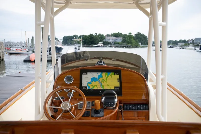 Slide: The Image of Helm of 2014 Hinckley Talaria 29C with navigation display, docked at marina. - 1