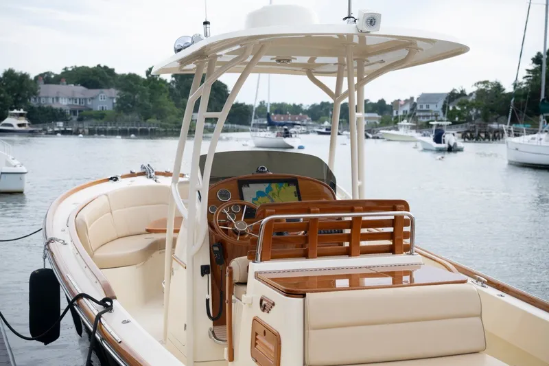Slide: The Image of 2014 Hinckley Talaria 29C boat docked, featuring elegant interior and advanced navigation system. - 19