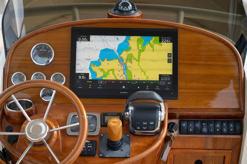 Slide: The Image of 2014 Hinckley Talaria 29C dashboard with GPS navigation and wooden steering wheel. - 17