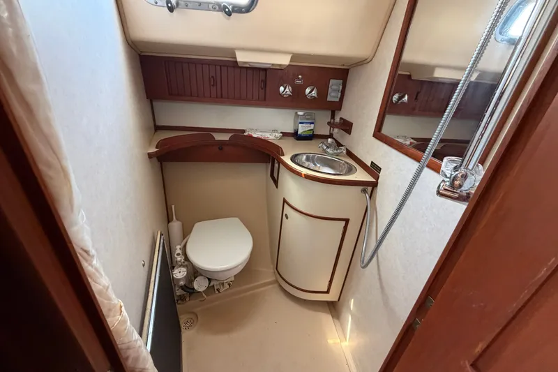 Slide: The Image of Compact bathroom in a 2000 Island Packet 320 sailboat with sink, toilet, and shower. - 80