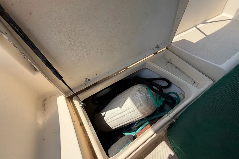 Slide: The Image of Storage compartment on a 2000 Island Packet 320 sailboat, containing boating equipment. - 45