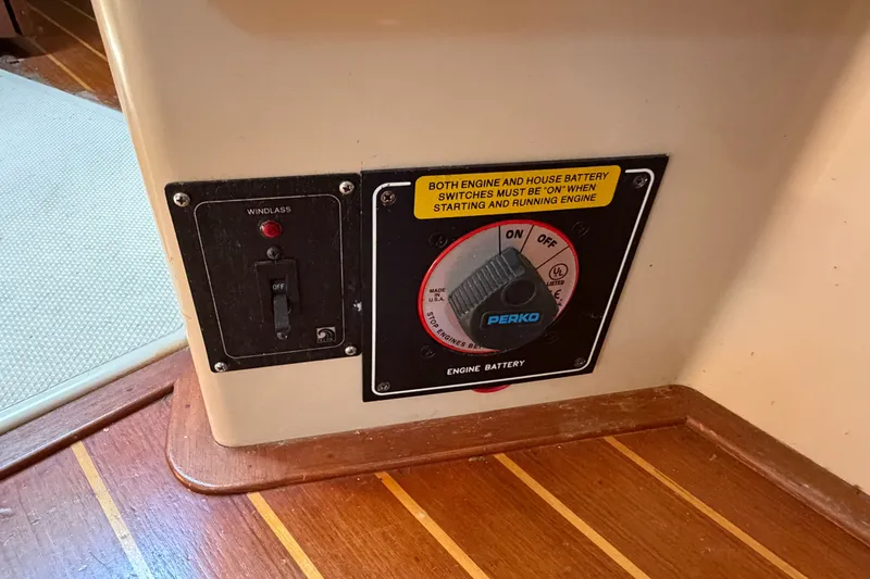 Slide: The Image of Control panel on a 2000 Island Packet 320 sailboat, featuring engine battery switch. - 76