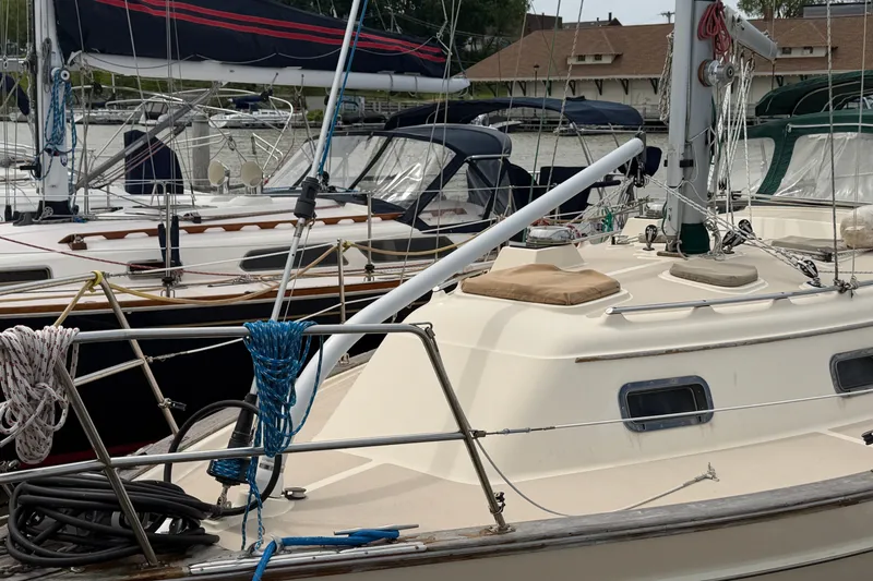 Slide: The Image of 2000 Island Packet 320 sailboat docked, featuring deck details and rigging. - 9