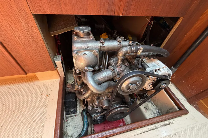 Slide: The Image of Engine compartment of a 2000 Island Packet 320 sailboat, showcasing mechanical components. - 83