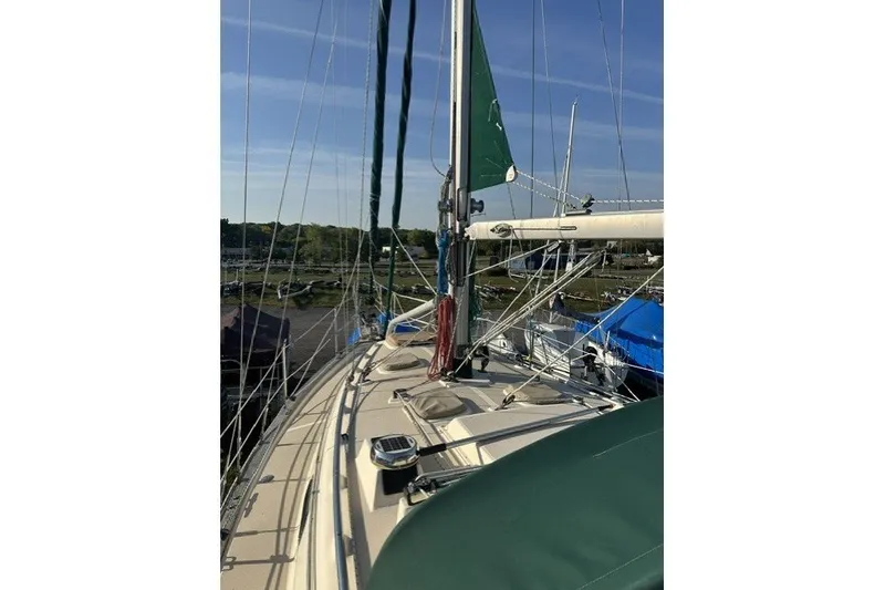 Slide: The Image of Sailboat deck view of 2000 Island Packet 320 under clear blue sky. - 26