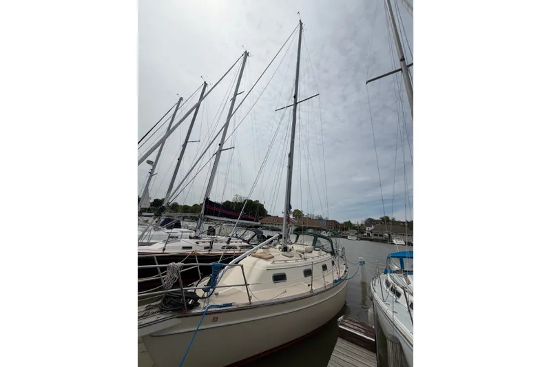 Slide: The Image of Sailboat docked at marina, Island Packet 320, year 2000, with overcast sky. - 6