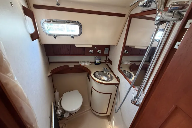 Slide: The Image of Compact bathroom in a 2000 Island Packet 320 sailboat with sink, toilet, and shower. - 81
