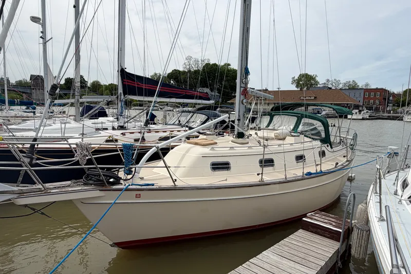 Slide: The Image of 2000 Island Packet 320 sailboat docked at marina, surrounded by other boats. - 5