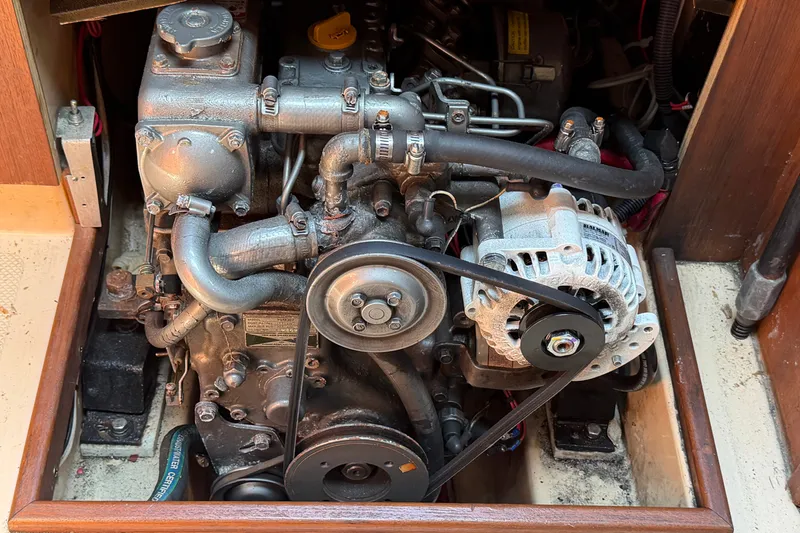 Slide: The Image of Engine compartment of a 2000 Island Packet 320 sailboat, showcasing mechanical components. - 84