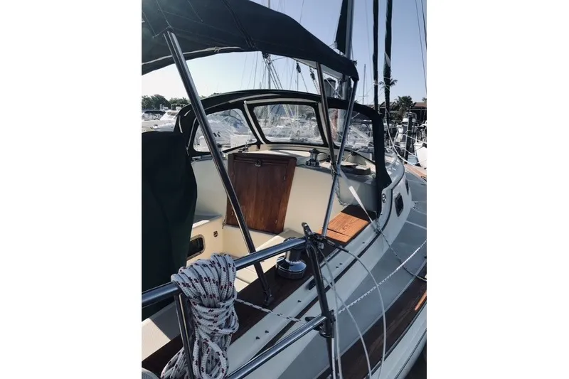 Slide: The Image of Island Packet 320 sailboat cockpit, 2000 model, featuring a sleek design and wooden accents. - 33