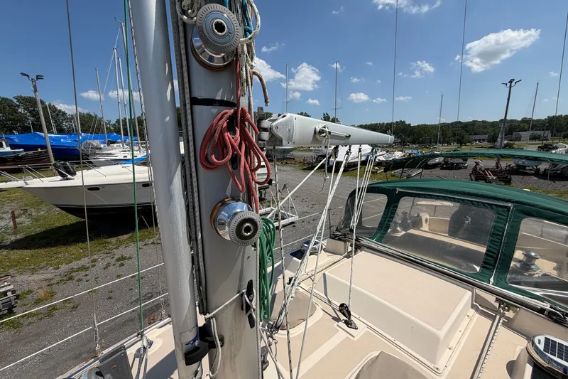 Slide: The Image of 2000 Island Packet 320 sailboat deck with rigging and winches, docked in a marina. - 28
