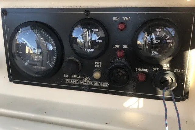 Slide: The Image of Control panel of a 2000 Island Packet 320 yacht with RPM, temperature, and oil gauges. - 41