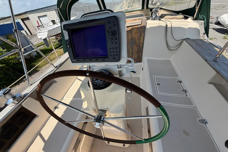 Slide: The Image of Cockpit of 2000 Island Packet 320 sailboat with steering wheel and navigation system. - 35