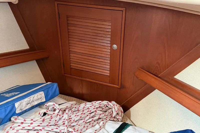 Slide: The Image of Interior of 2000 Island Packet 320 sailboat with wooden cabinet and nautical equipment. - 73