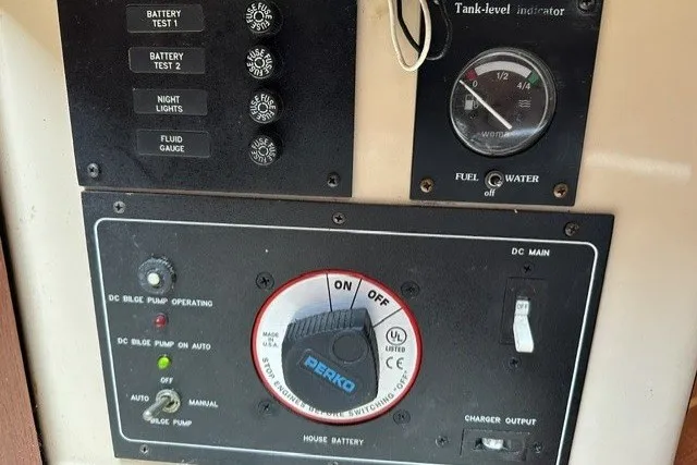 Slide: The Image of Control panel of a 2000 Island Packet 320 sailboat with battery and tank indicators. - 75