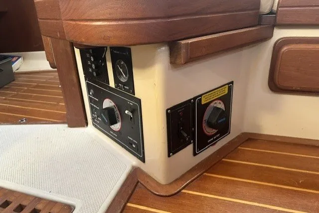 Slide: The Image of Control panel of a 2000 Island Packet 320 sailboat interior with wood accents. - 77