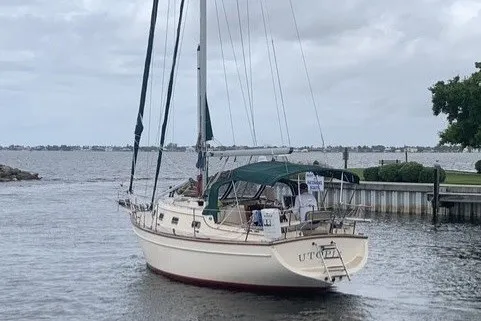 Slide: The Image of 2000 Island Packet 320 sailboat docked on a calm, cloudy day. - 3