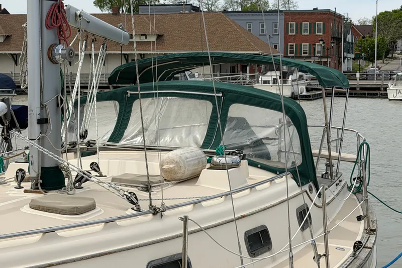 Slide: The Image of Sailboat Island Packet 320, 2000 model, docked with green canopy and rigging. - 10