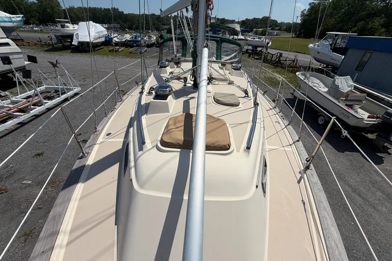 Slide: The Image of 2000 Island Packet 320 sailboat on dry dock, surrounded by other boats. - 27