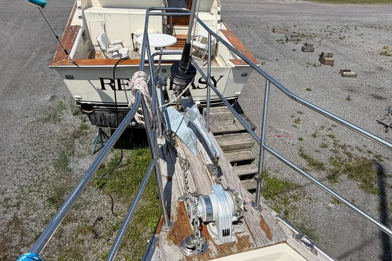 Slide: The Image of Sailboat Island Packet 320, year 2000, docked on gravel with visible deck and equipment. - 19