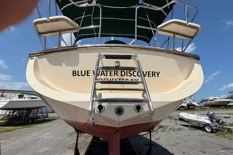 Slide: The Image of Island Packet 320 sailboat, 2000 model, named "Blue Water Discovery," docked on land. - 14