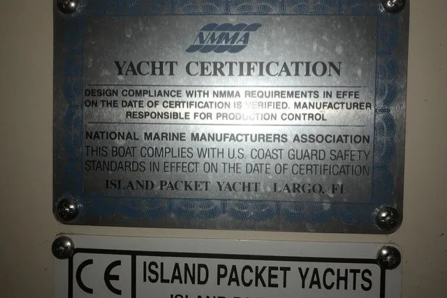 Slide: The Image of Yacht certification plaque for 2000 Island Packet 320, verifying compliance with safety standards. - 98