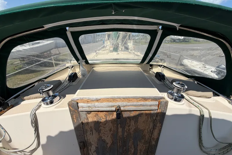 Slide: The Image of Cockpit view of a 2000 Island Packet 320 sailboat with green canopy and winches. - 32