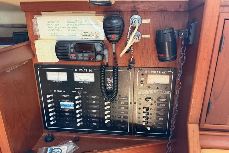Slide: The Image of Electrical control panel on a 2000 Island Packet 320 yacht, featuring 12V DC and 120V AC systems. - 69