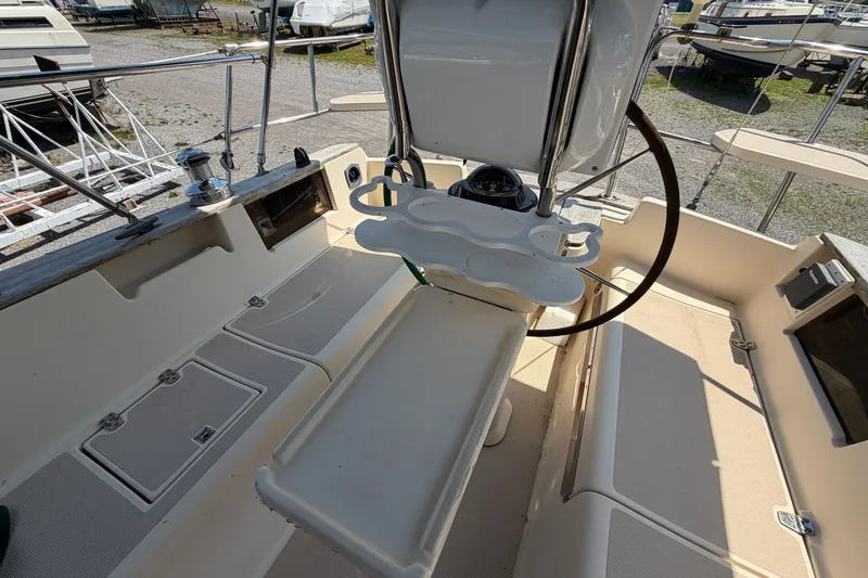 Slide: The Image of Cockpit of 2000 Island Packet 320 sailboat with steering wheel and seating. - 34